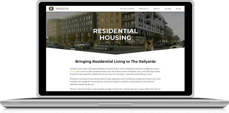 image of laptop displaying web page of the A.J. development